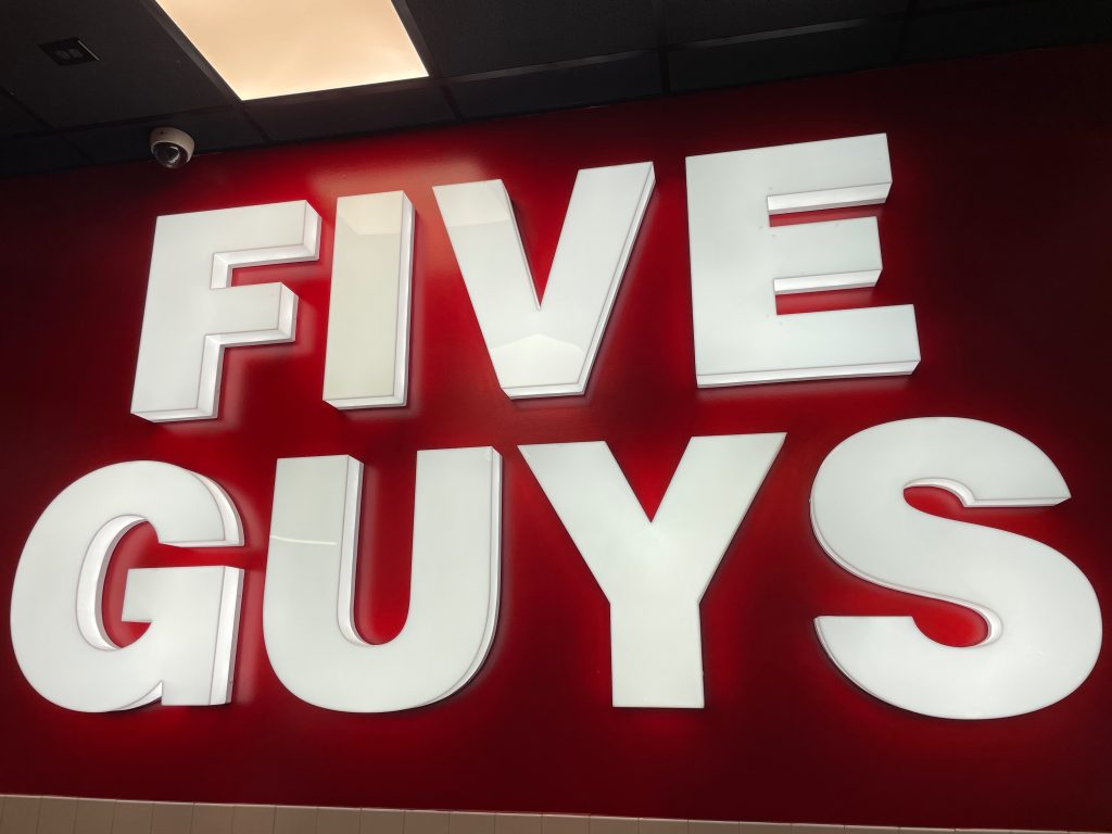 Det ikoniske lysskilt præger facaden på Five Guys i Hamburg, hvor restauranten ligger centralt for enden af den berømte (og berygtede) Reeperbahn.